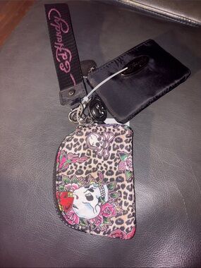 Ed Hardy card pouch with leopard print and skull-and-rose motifs.
